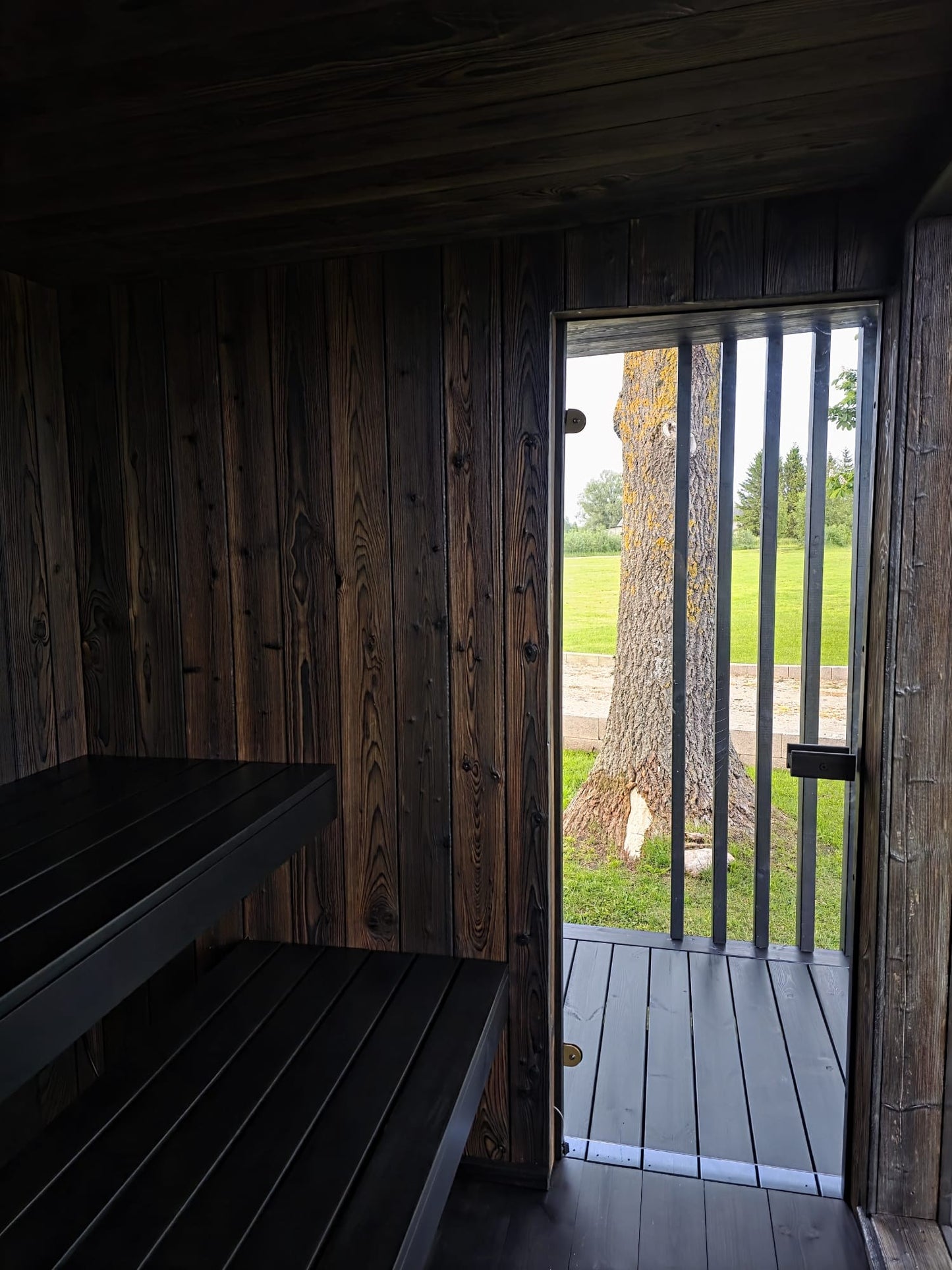 Luxury wooden sauna with ancient Japanese wood-burning finish and glass details
