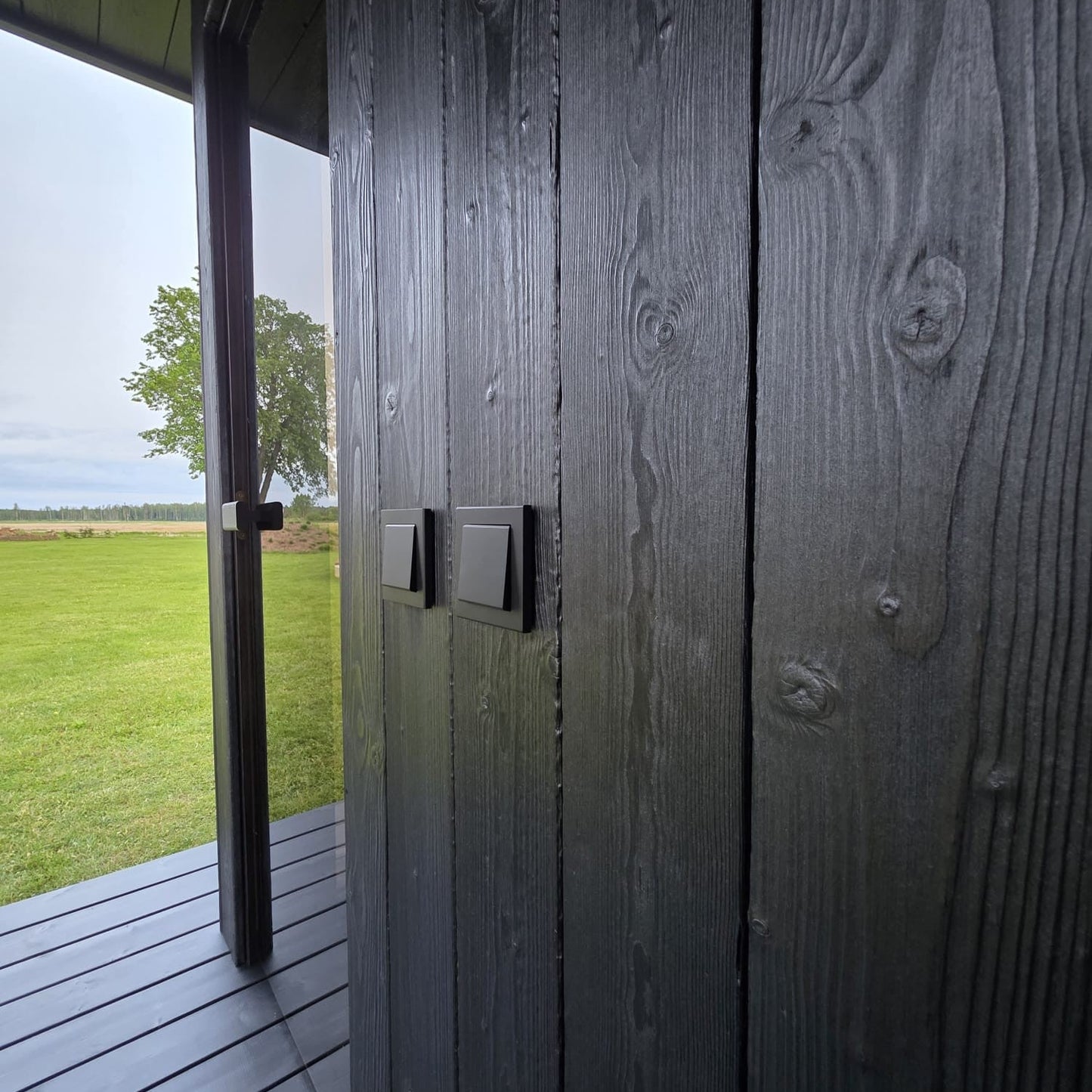 Luxury wooden sauna with ancient Japanese wood-burning finish and glass details
