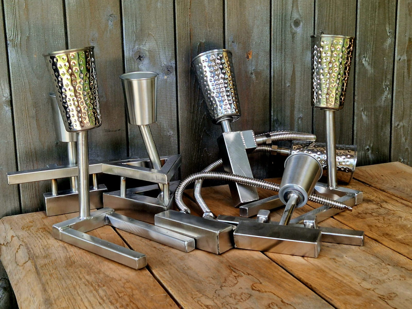 Metallic kitchen grating set on a wooden surface with a wooden panel background