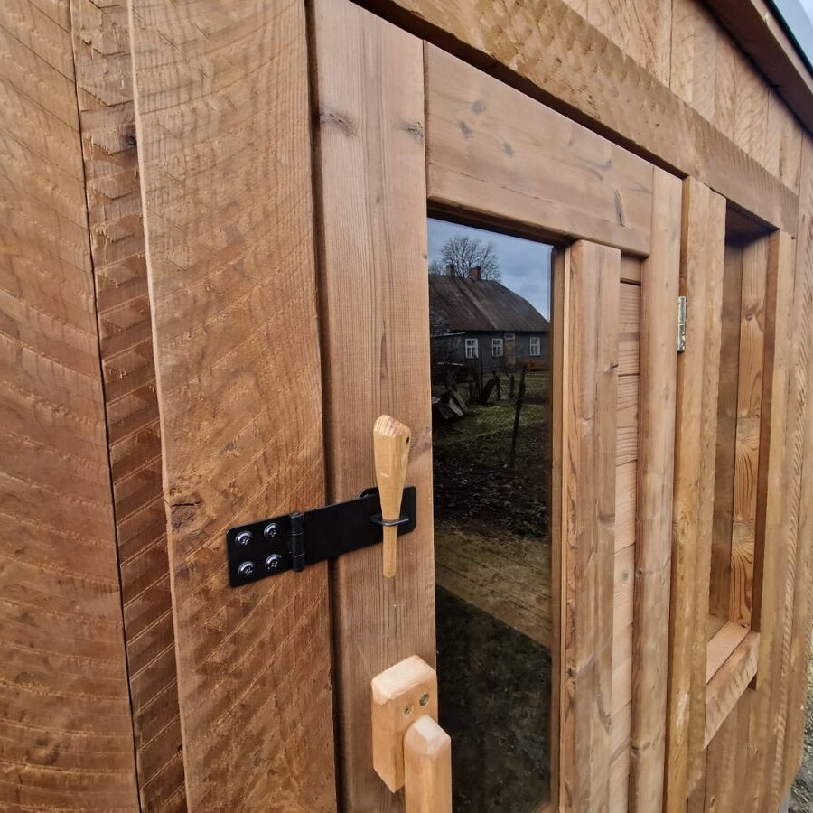 Modern compact outdoor sauna with Thermowood finish for gardens