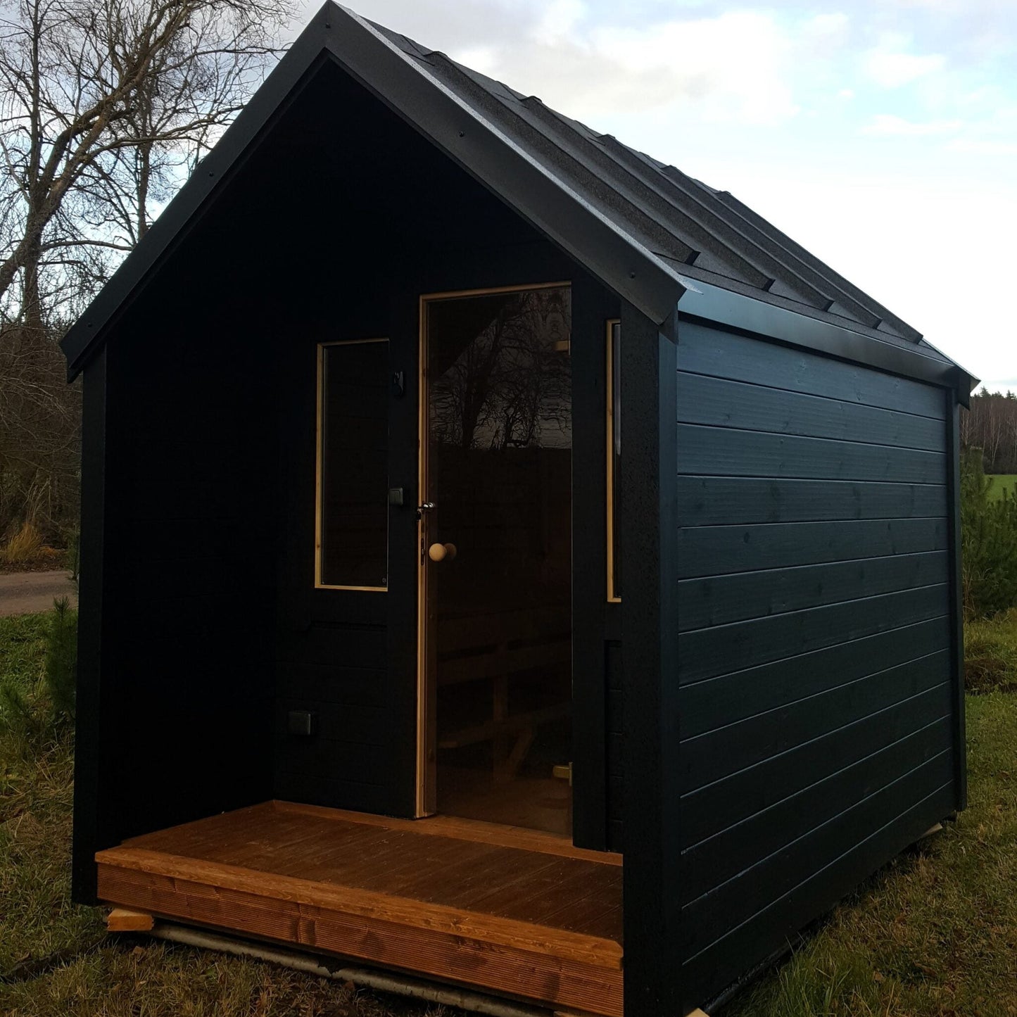 Traditional sauna cabin with terrace and gable roof design