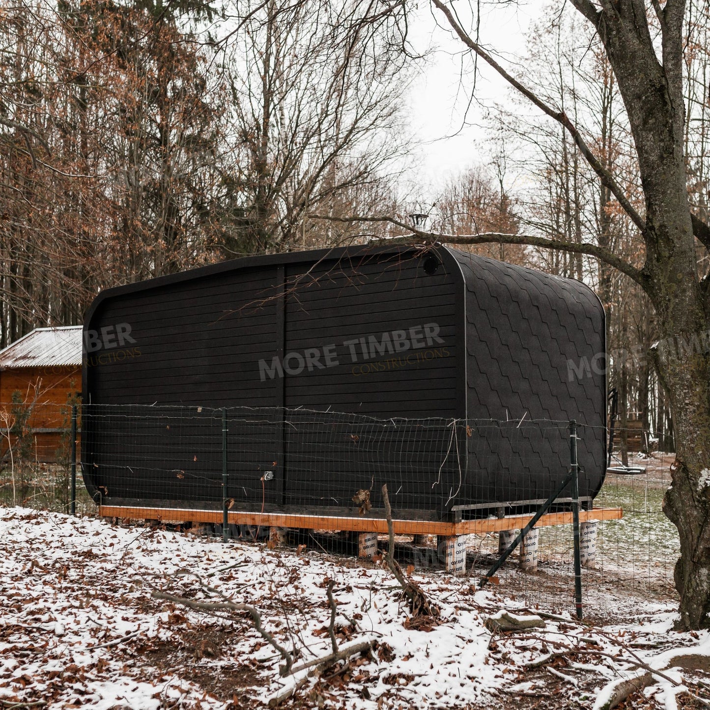 Sauna and hot tub surrounded by lush greenery
