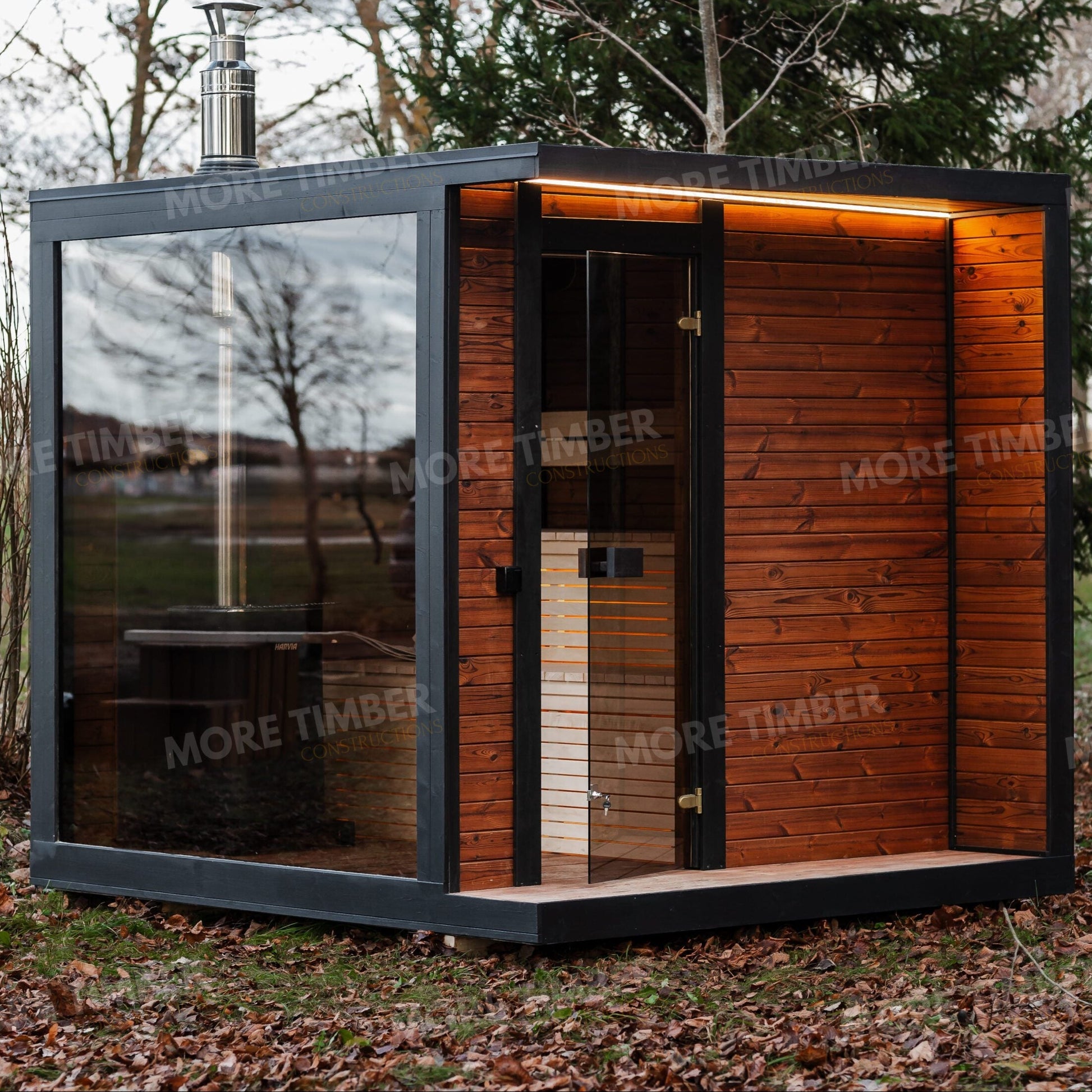 Wooden sauna with 'More Timber' branding, featuring wooden benches and a door.