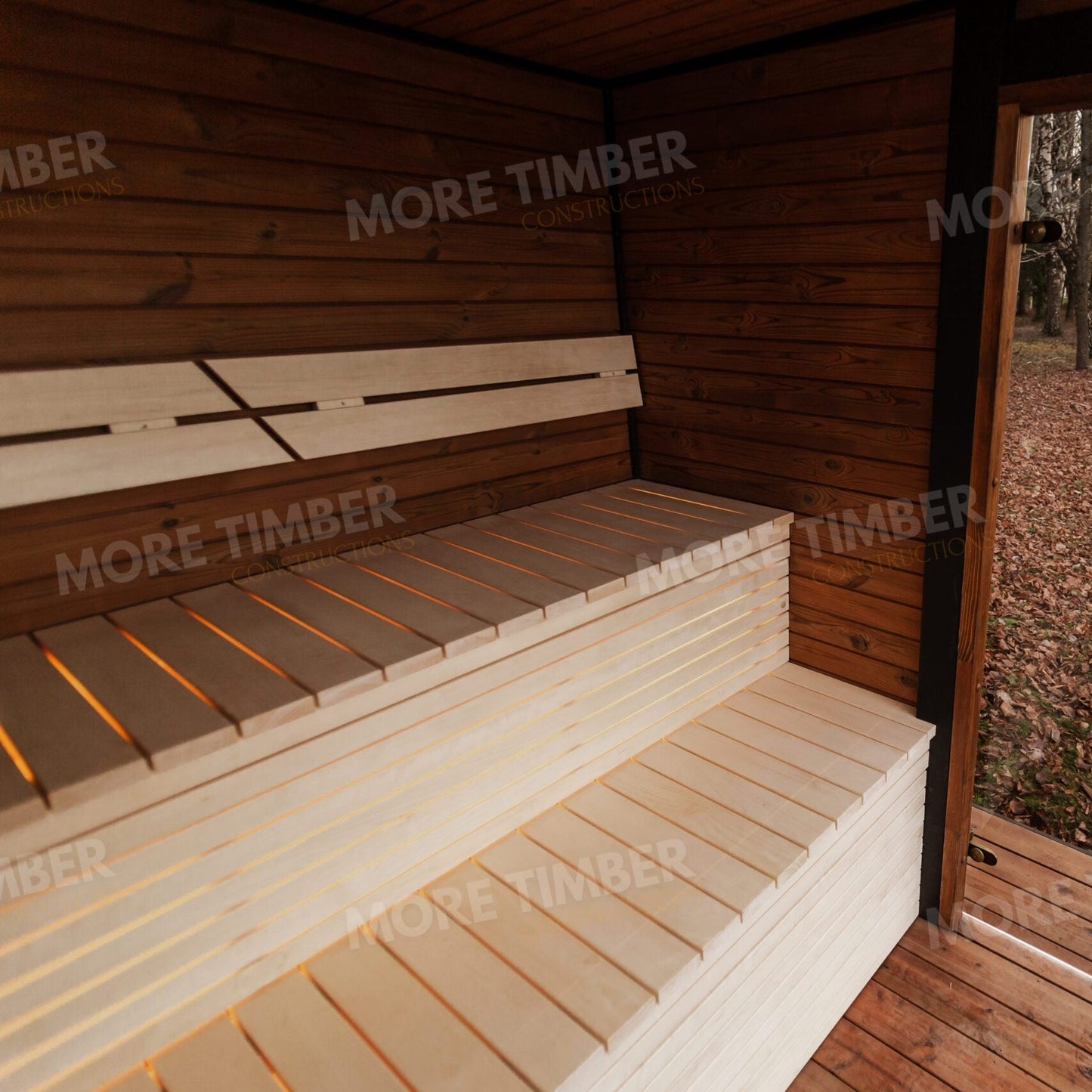 Natural wood sauna with glass door and subtle steam