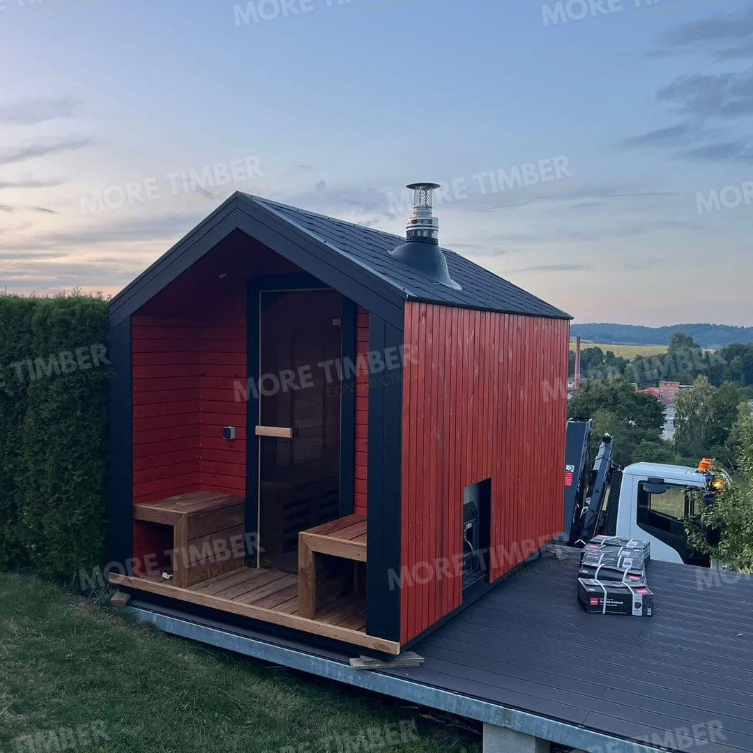 Wooden sauna with 'More Timber' branding, featuring wooden benches and a door.