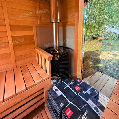 Wooden sauna with 'More Timber' branding, featuring wooden benches and a door.