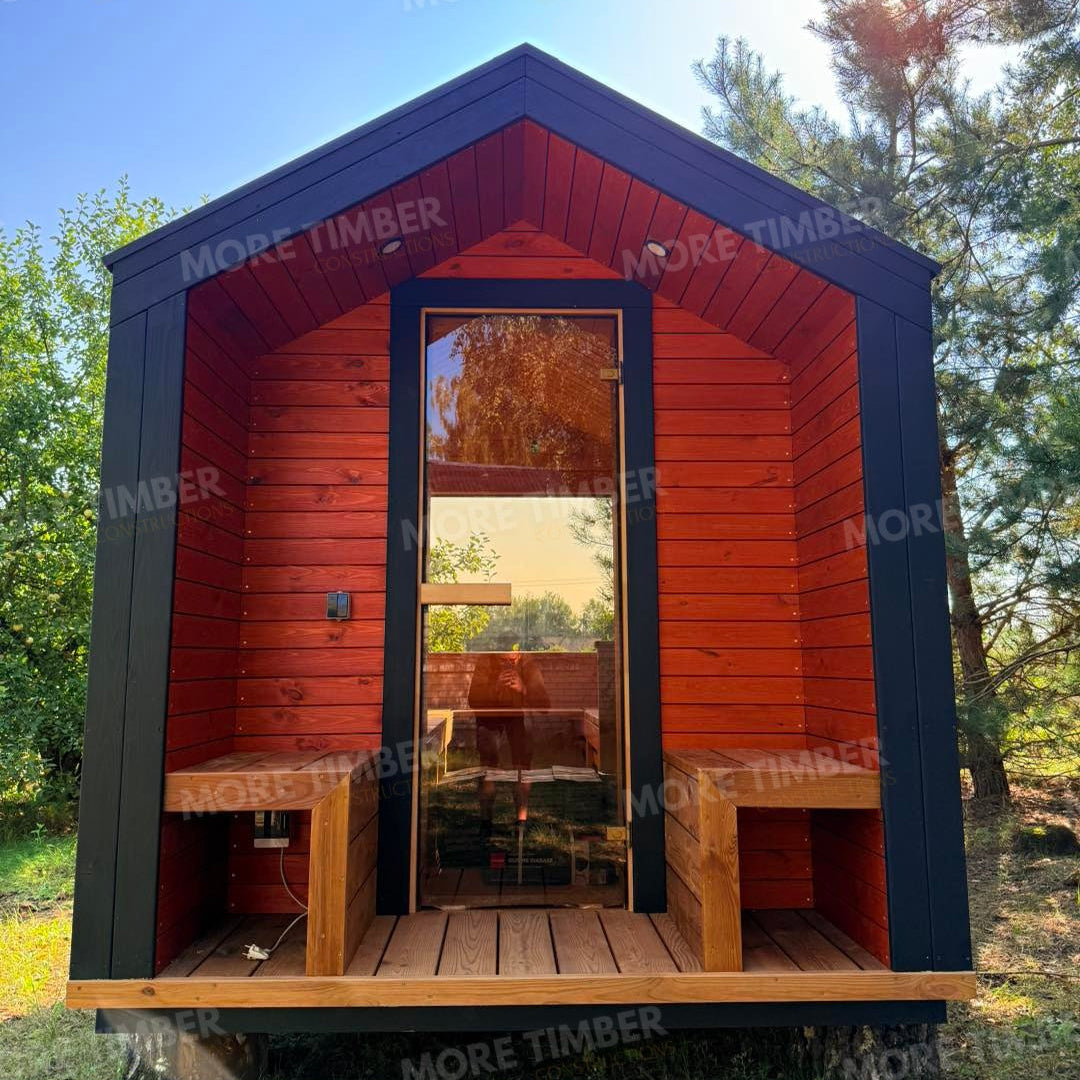 Wooden sauna with 'More Timber' branding, featuring wooden benches and a door.