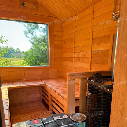 Wooden sauna with 'More Timber' branding, featuring wooden benches and a door.