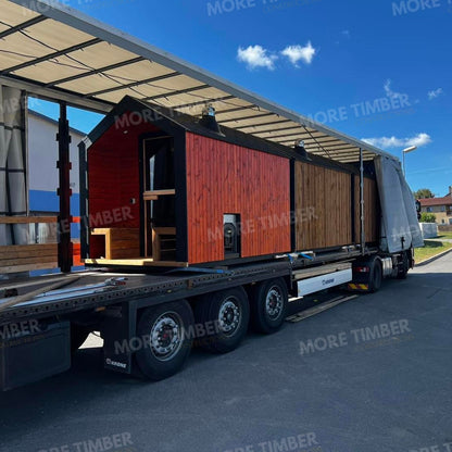 Wooden sauna with 'More Timber' branding, featuring wooden benches and a door.