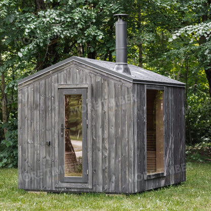 Warm wooden sauna with bucket and ladle on bench