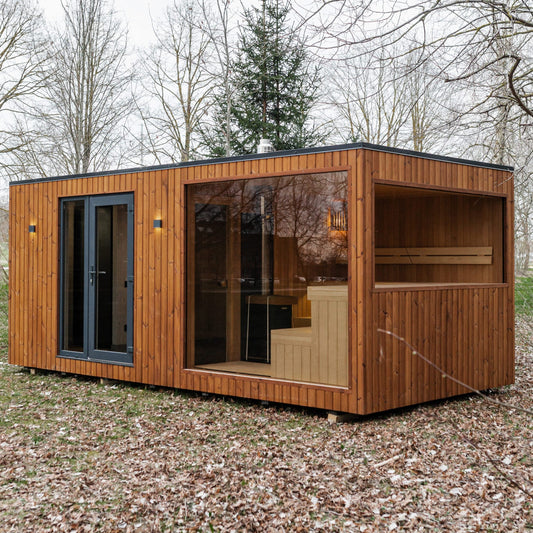 Wooden cabin with glass windows in a forest setting