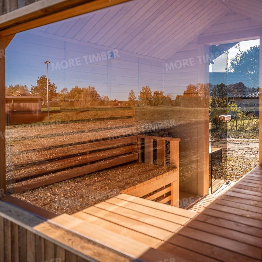 Wooden sauna with 'More Timber' branding, featuring wooden benches and a door.