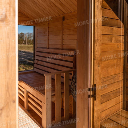 Wooden sauna with 'More Timber' branding, featuring wooden benches and a door.