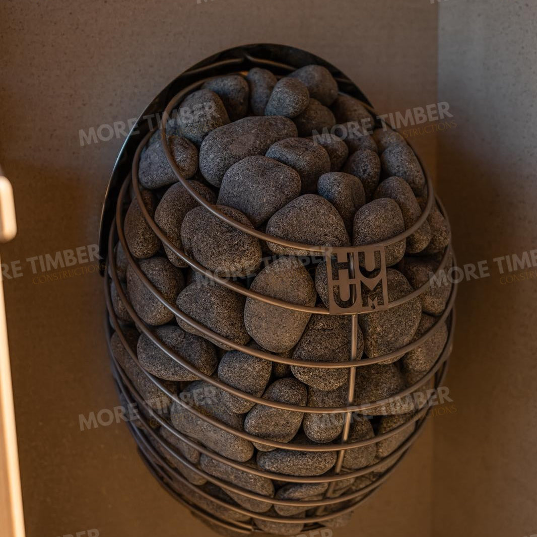 Wooden sauna with 'More Timber' branding, featuring wooden benches and a door.