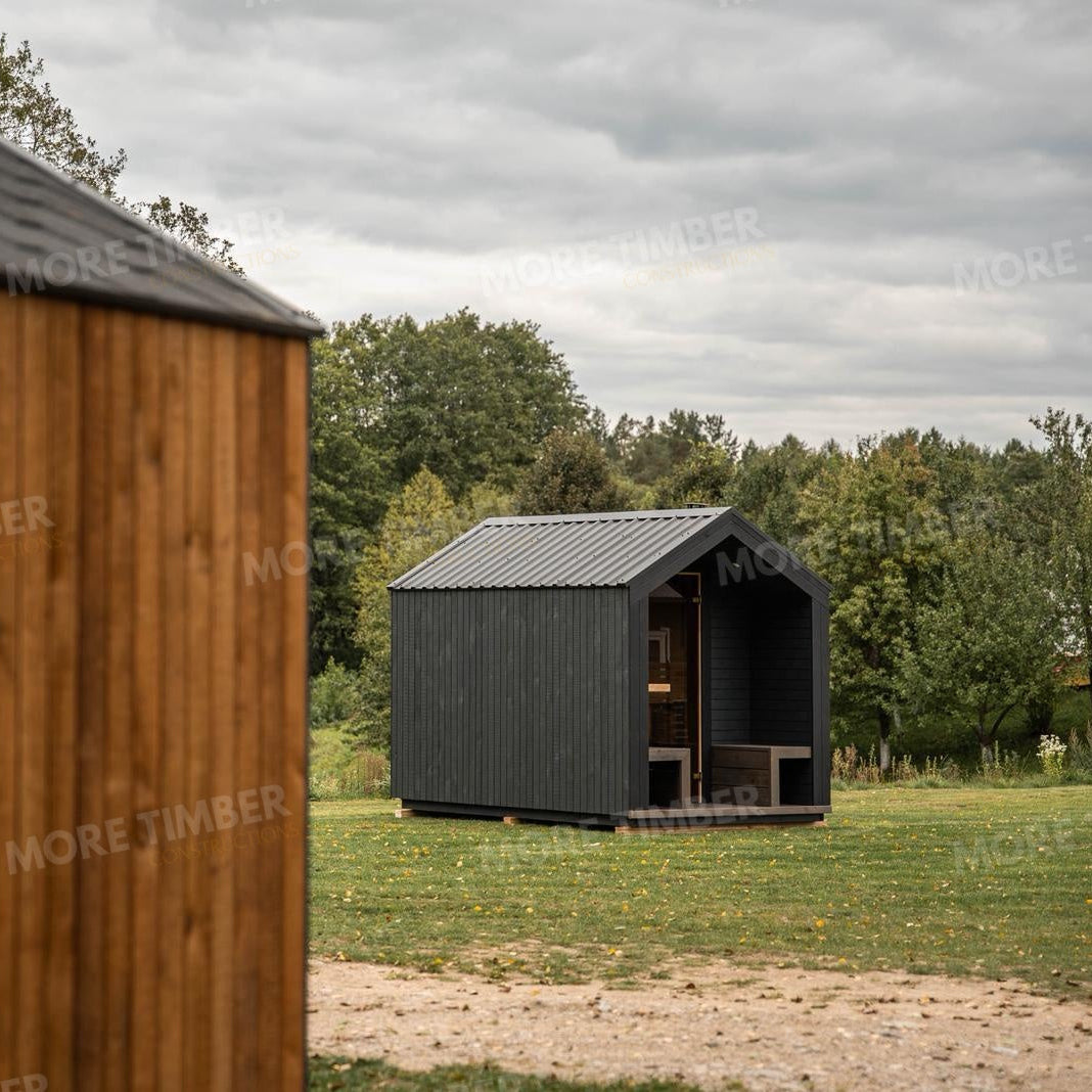 Wooden sauna with 'More Timber' branding, featuring wooden benches and a door.