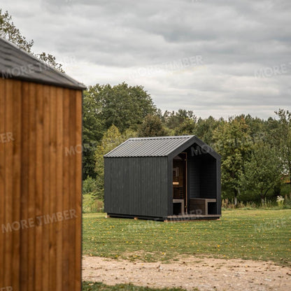 Wooden sauna with 'More Timber' branding, featuring wooden benches and a door.