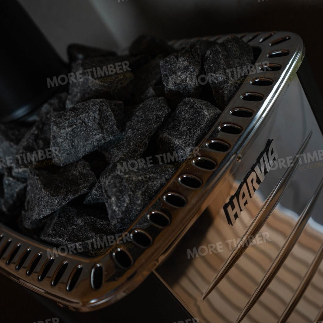 Wooden sauna with 'More Timber' branding, featuring wooden benches and a door.