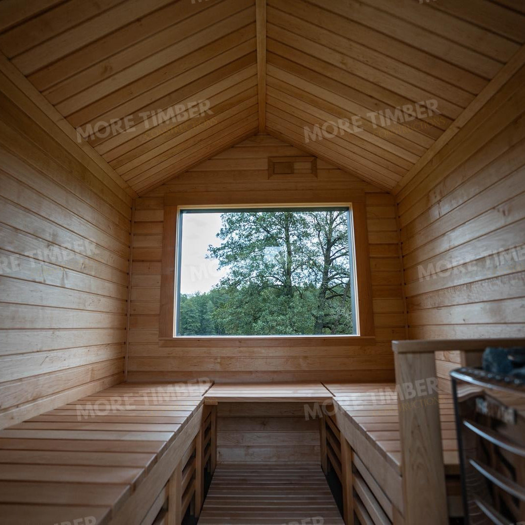 Wooden sauna with 'More Timber' branding, featuring wooden benches and a door.