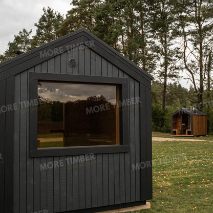 Wooden sauna with 'More Timber' branding, featuring wooden benches and a door.