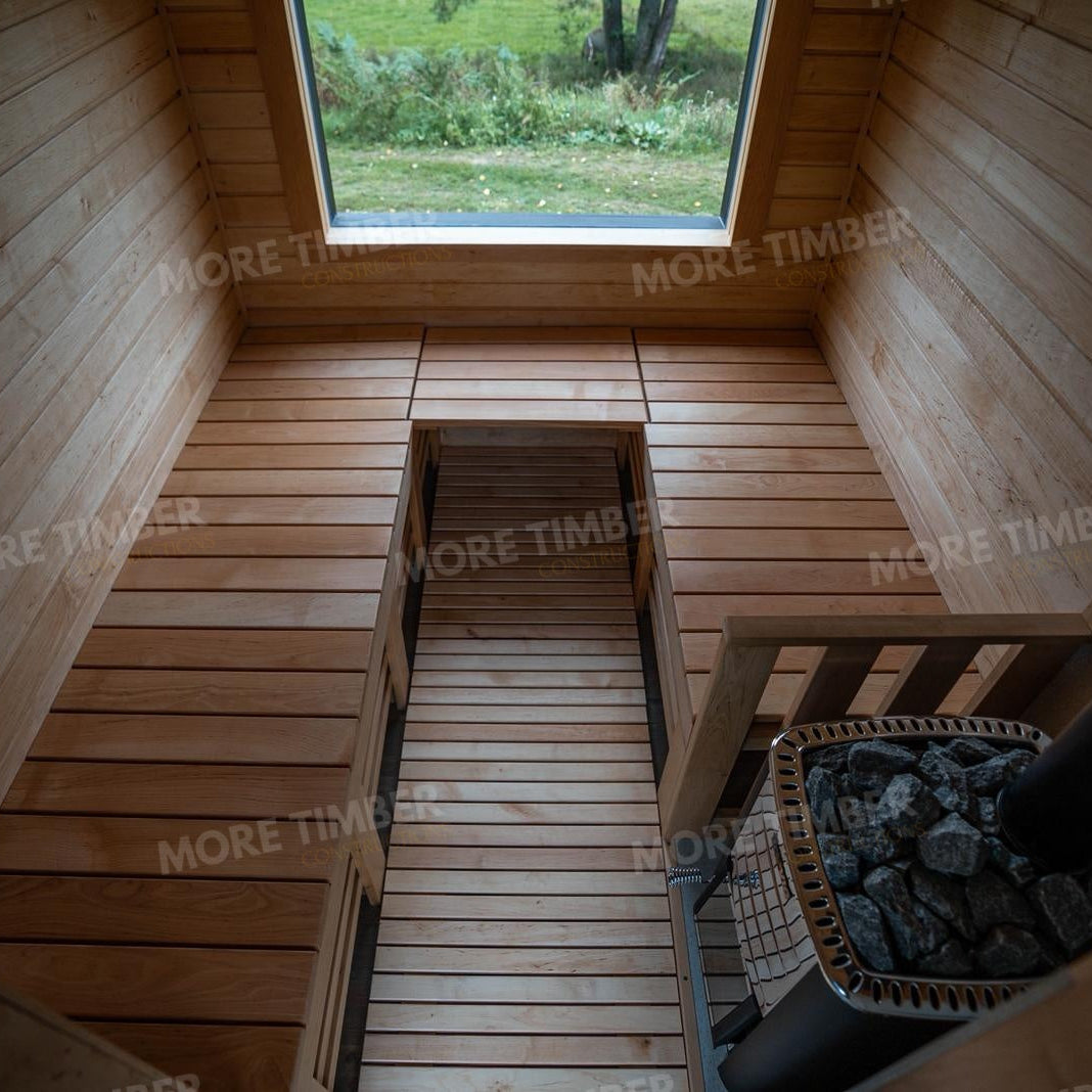 Wooden sauna with 'More Timber' branding, featuring wooden benches and a door.