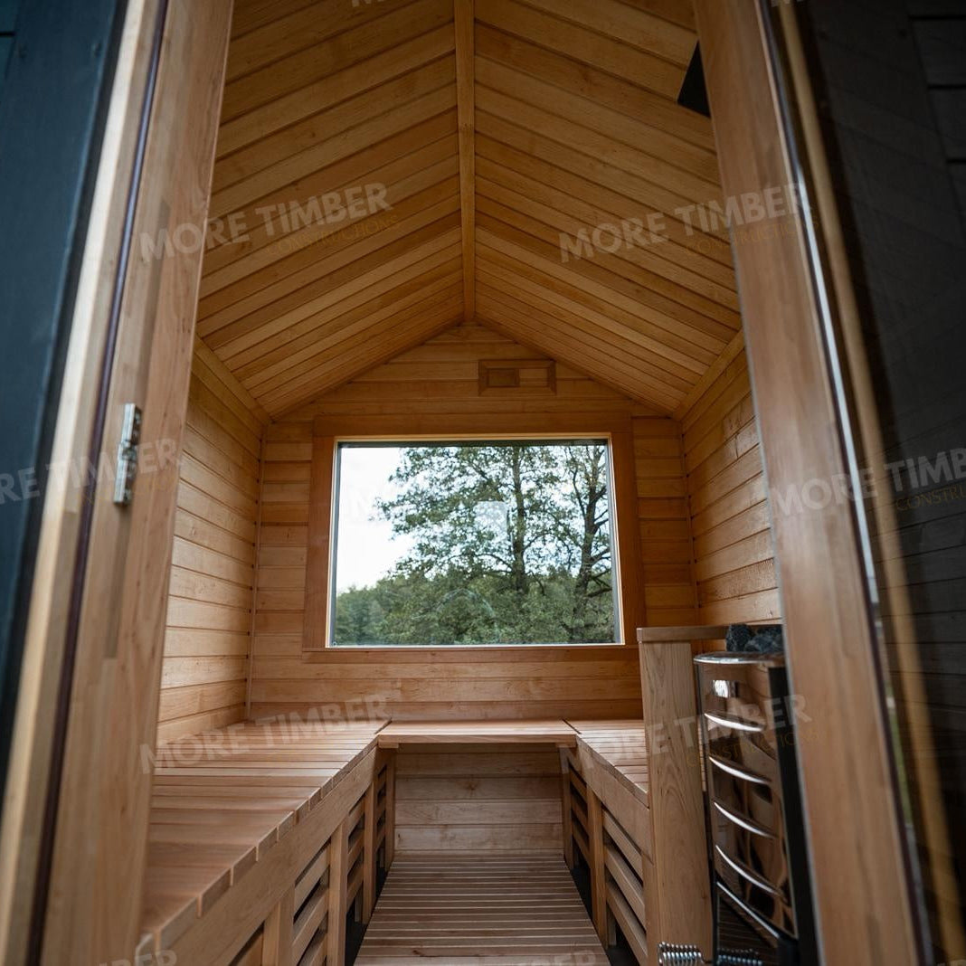 Wooden sauna with 'More Timber' branding, featuring wooden benches and a door.