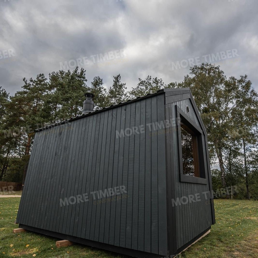 Wooden sauna with 'More Timber' branding, featuring wooden benches and a door.