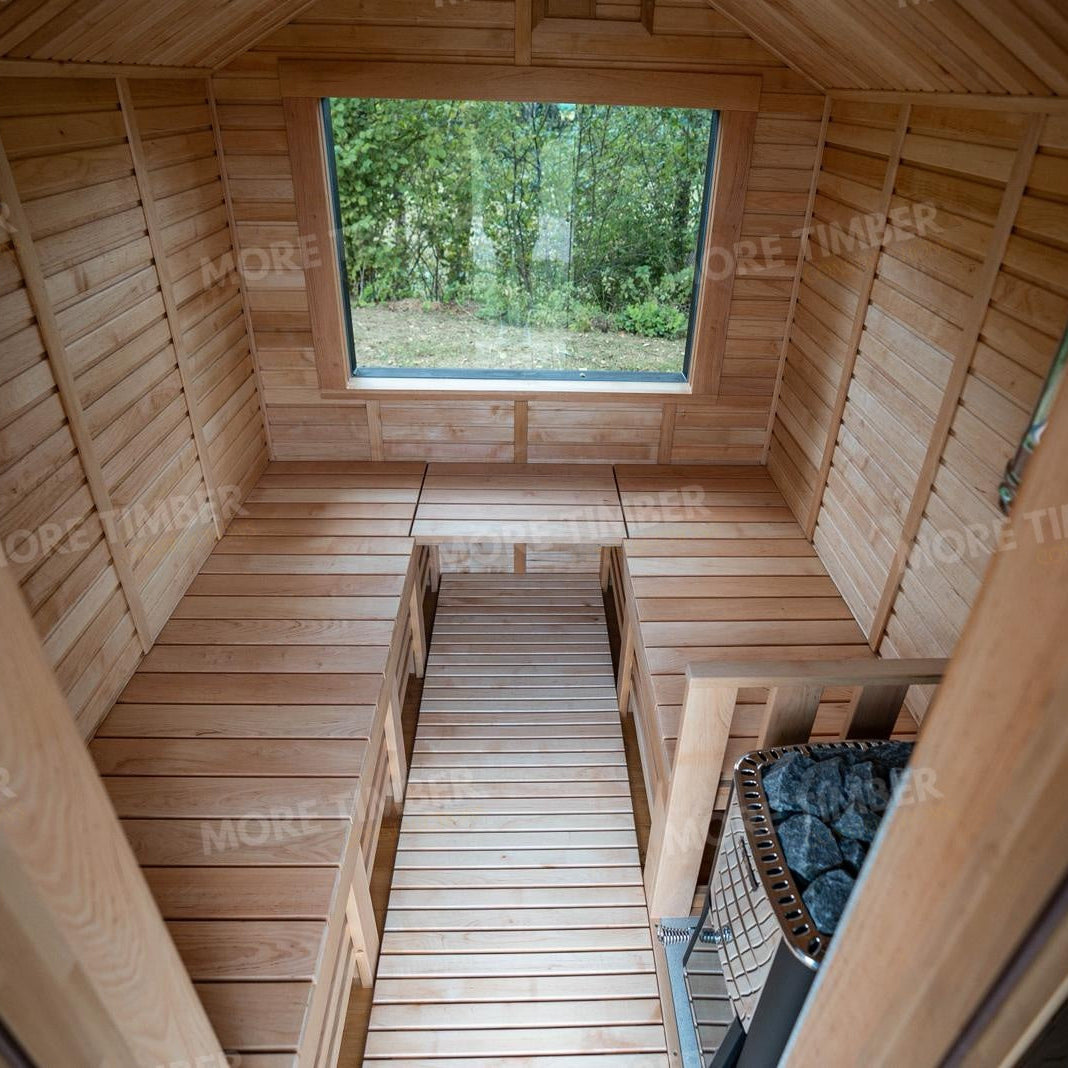 Wooden sauna with 'More Timber' branding, featuring wooden benches and a door.
