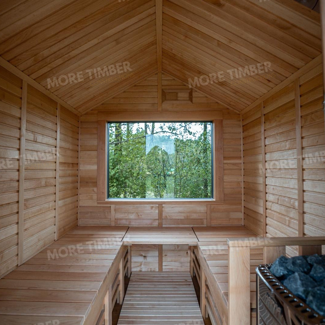 Wooden sauna with 'More Timber' branding, featuring wooden benches and a door.