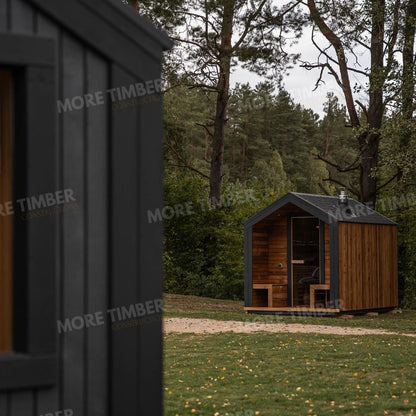 Wooden sauna with 'More Timber' branding, featuring wooden benches and a door.