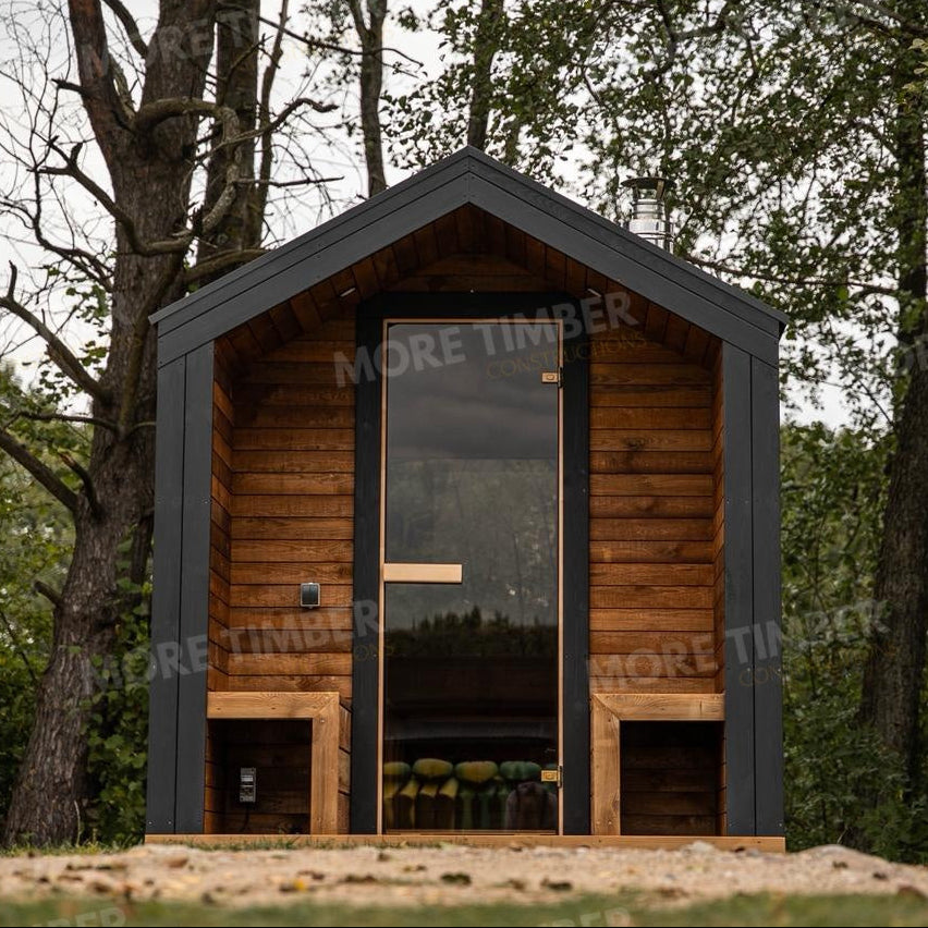 Wooden sauna with 'More Timber' branding, featuring wooden benches and a door.
