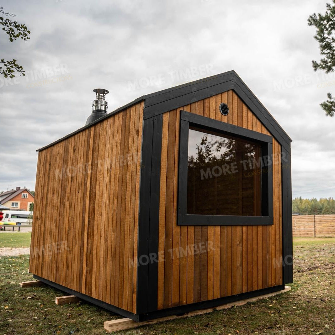 Wooden sauna with 'More Timber' branding, featuring wooden benches and a door.
