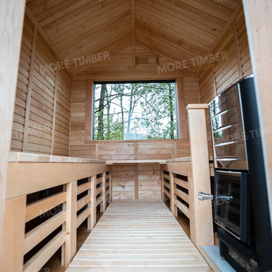 Wooden sauna with 'More Timber' branding, featuring wooden benches and a door.