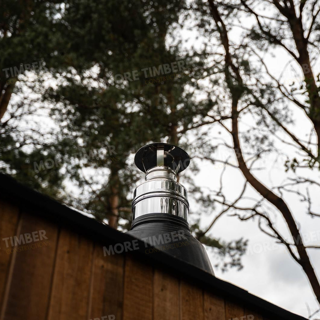 Wooden sauna with 'More Timber' branding, featuring wooden benches and a door.