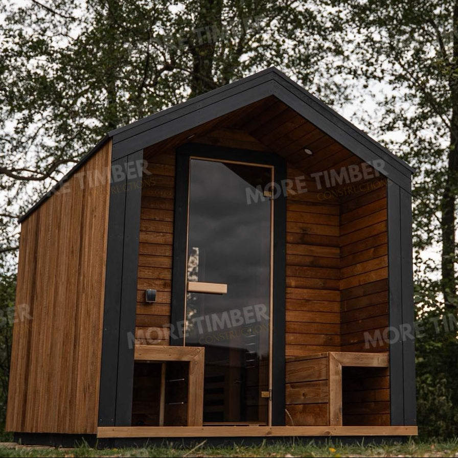 Wooden sauna with 'More Timber' branding, featuring wooden benches and a door.