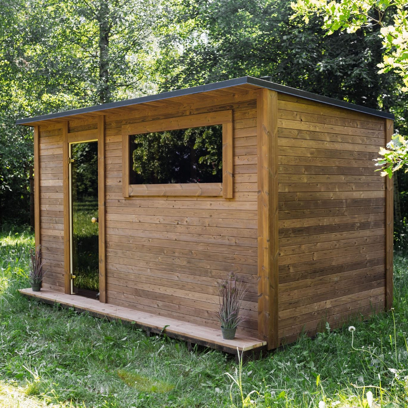 Scandinavian-style garden sauna with changing room and tempered glass door