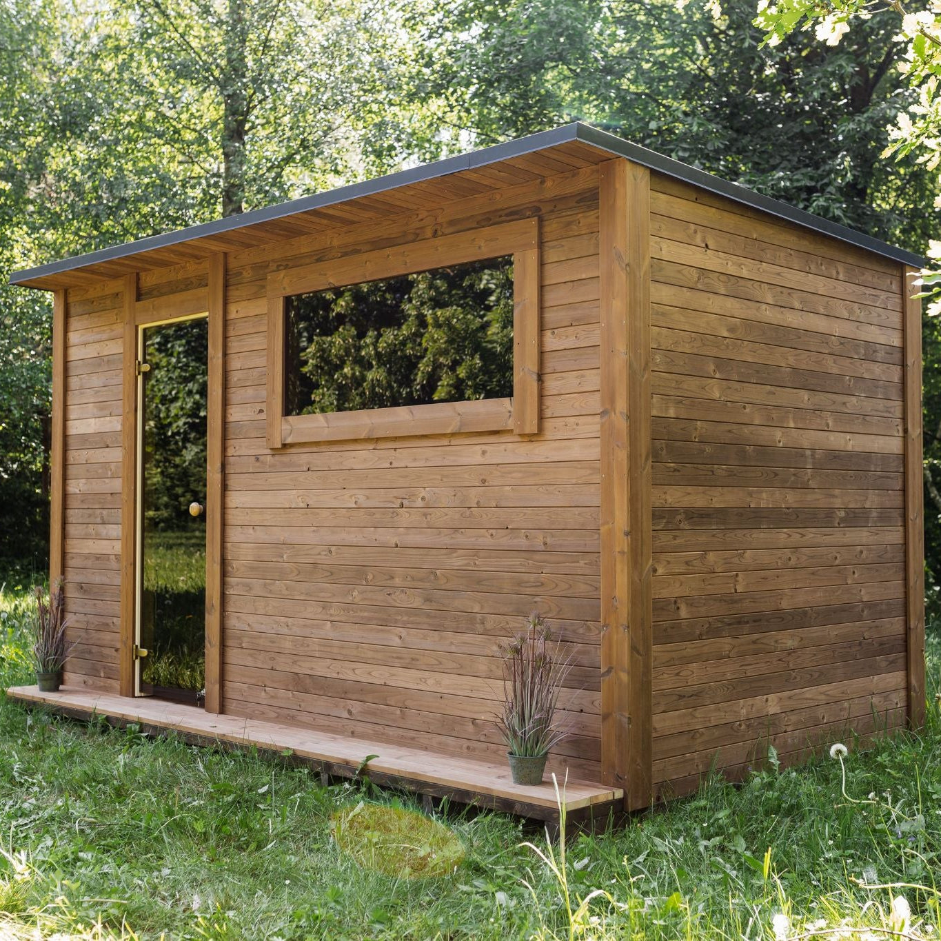 Thermowood sauna with front window allowing natural light