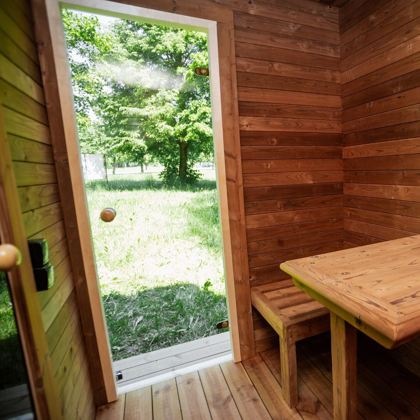 Thermowood garden sauna with large tempered glass windows